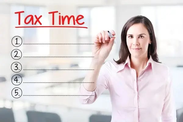depositphotos_98179908-stock-photo-business-woman-writing-blank-tax